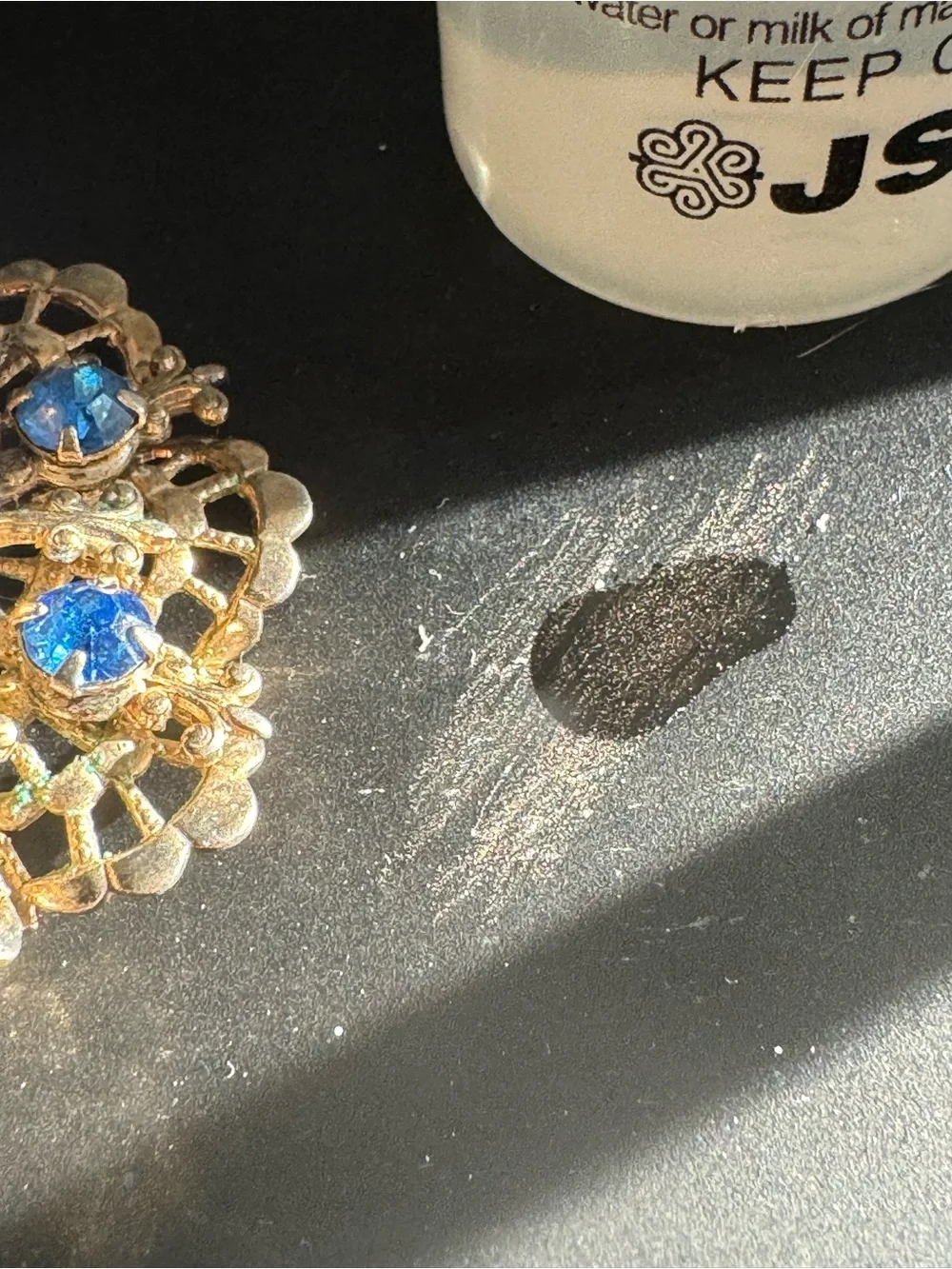 Gold-Tone Floral Brooch with Blue Crystal Accents and Iridescent Center